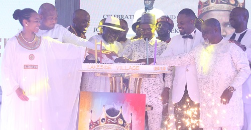 Joseph KingKong Agbeko aided by some dignitaries to cut the cake